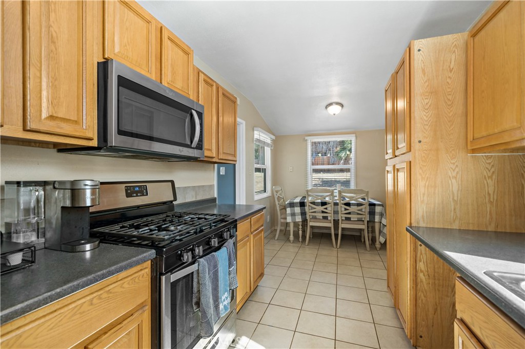 6006 Colonial Drive Riverside, CA 92506 - Photo 12 of 36 a kitchen with stainless steel appliances granite countertop a stove and a microwave