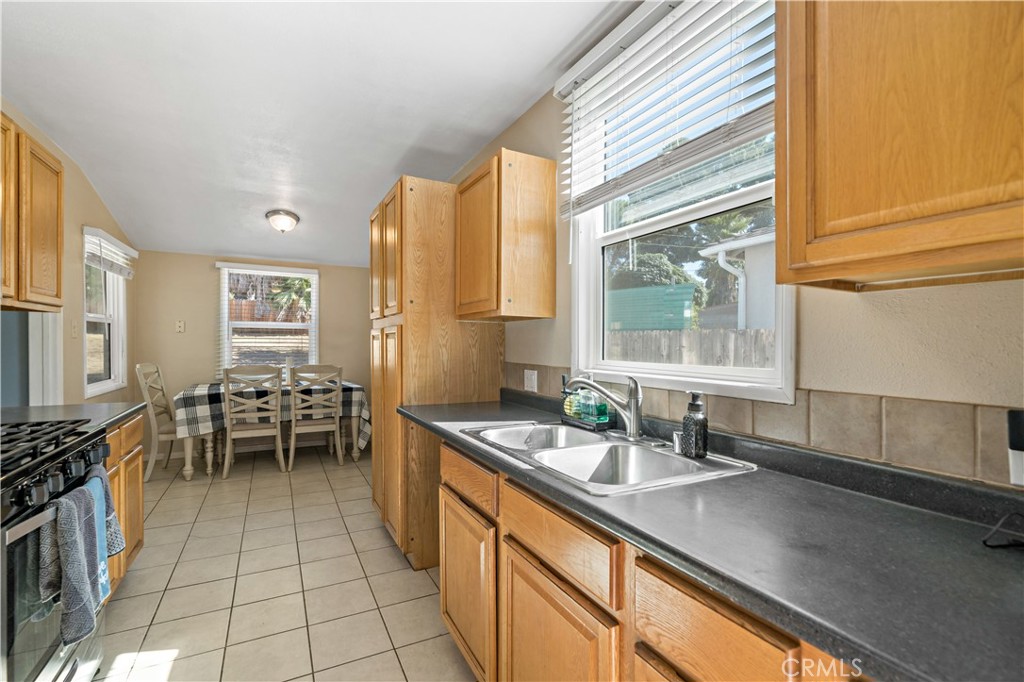6006 Colonial Drive Riverside, CA 92506 - Photo 13 of 36 a kitchen with sink cabinets and stove