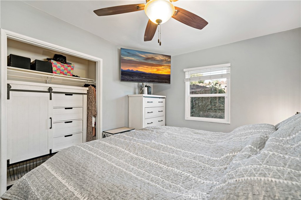 6006 Colonial Drive Riverside, CA 92506 - Photo 20 of 36 a bedroom with a bed and a flat screen tv