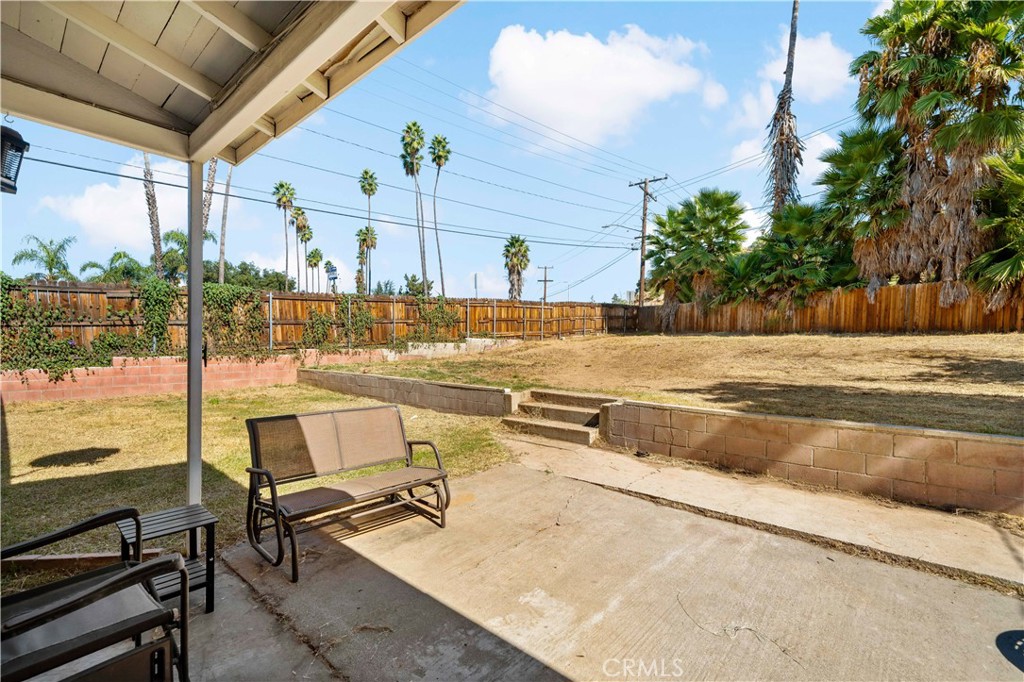 6006 Colonial Drive Riverside, CA 92506 - Photo 21 of 36 a view of a swimming pool with a lawn chairs under wooden roof with potted plants