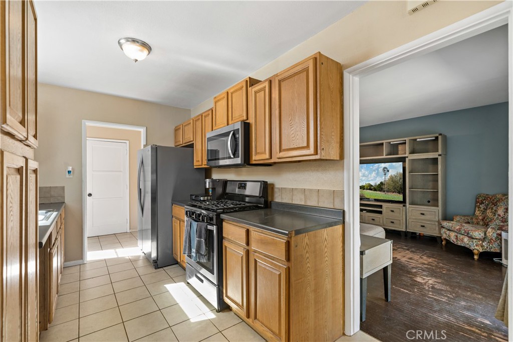 6006 Colonial Drive Riverside, CA 92506 - Photo 10 of 36 a kitchen with stainless steel appliances granite countertop a refrigerator stove and sink