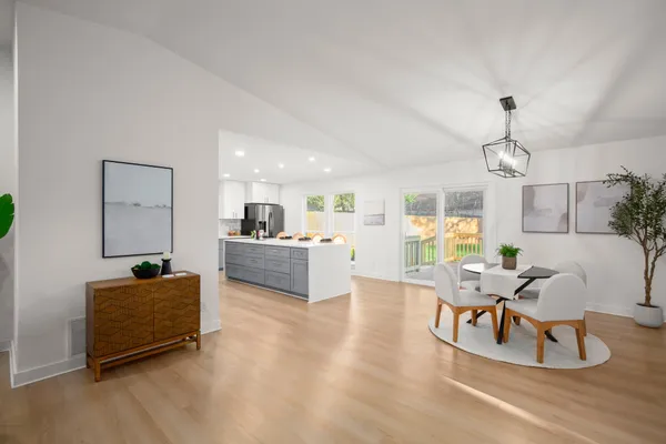 a living room with furniture and kitchen view