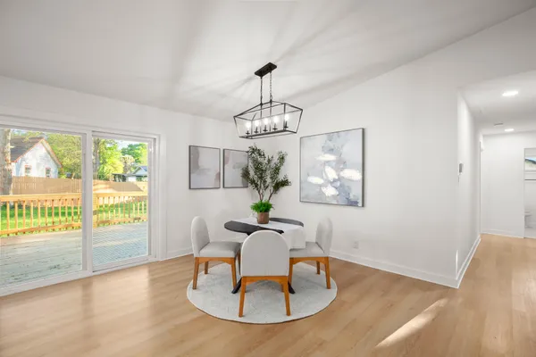 a view of a dining room with furniture wooden floor and a chandelier