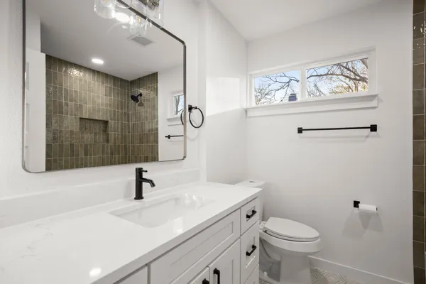 a bathroom with a sink toilet and shower