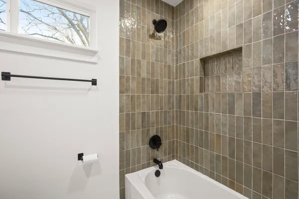 a bathroom with a bathtub and a shower