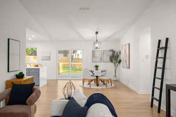 a living room with furniture a window and a chandelier