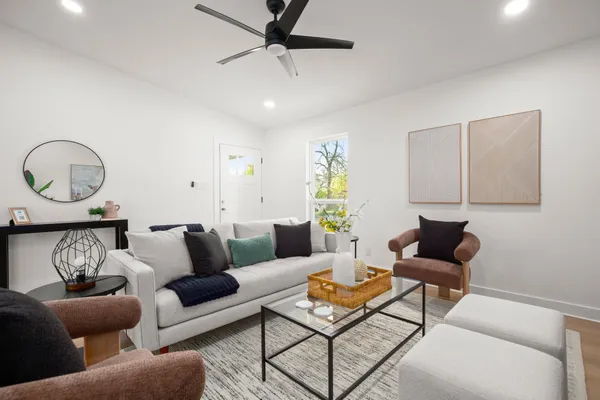 a living room with furniture and a wooden floor
