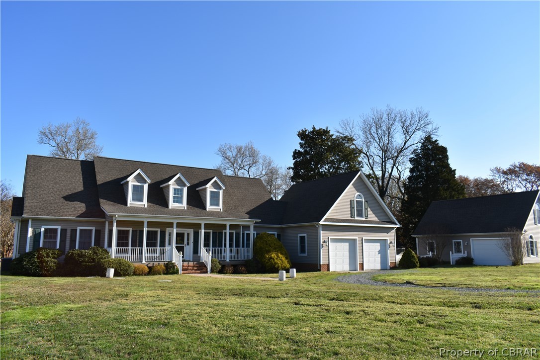 163 Mill Lane Road Cardinal, VA 23025 - Photo 3 of 50 a front view of a house with a garden