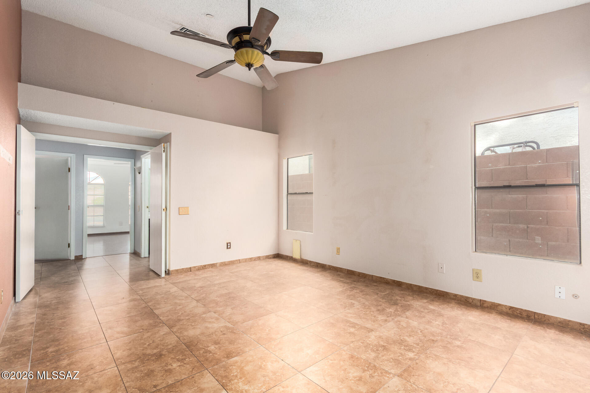 5331 West Eaglestone Loop Tucson, AZ 85742 - Photo 17 of 35 a view of a room with a ceiling fan and a window
