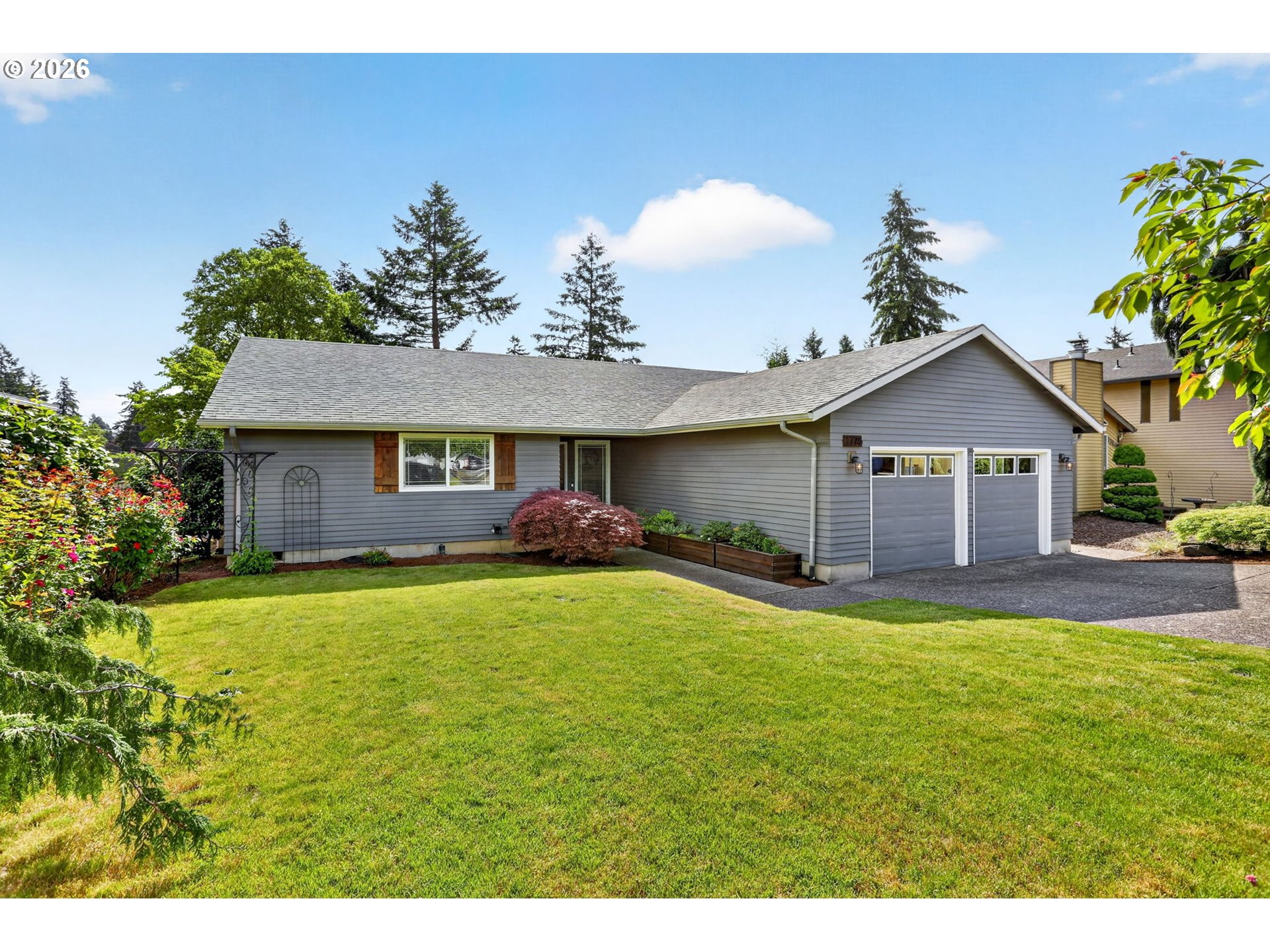 1776 Southeast 114th Place Portland, OR 97216 - Photo 4 of 47 a front view of a house with a yard and garage