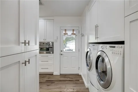a view of a storage and utility room with washer and dryer