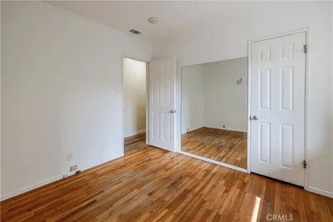 a view of a room with wooden floor