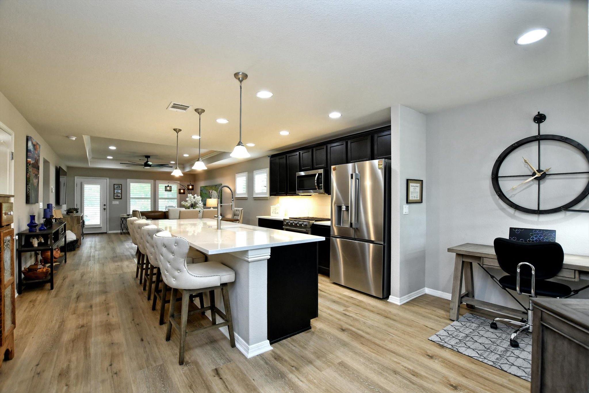 231 Hobby Street Georgetown, TX 78633 - Photo 12 of 29 An inviting open-concept kitchen and living area showcases an oversized island and ample space for dining.
