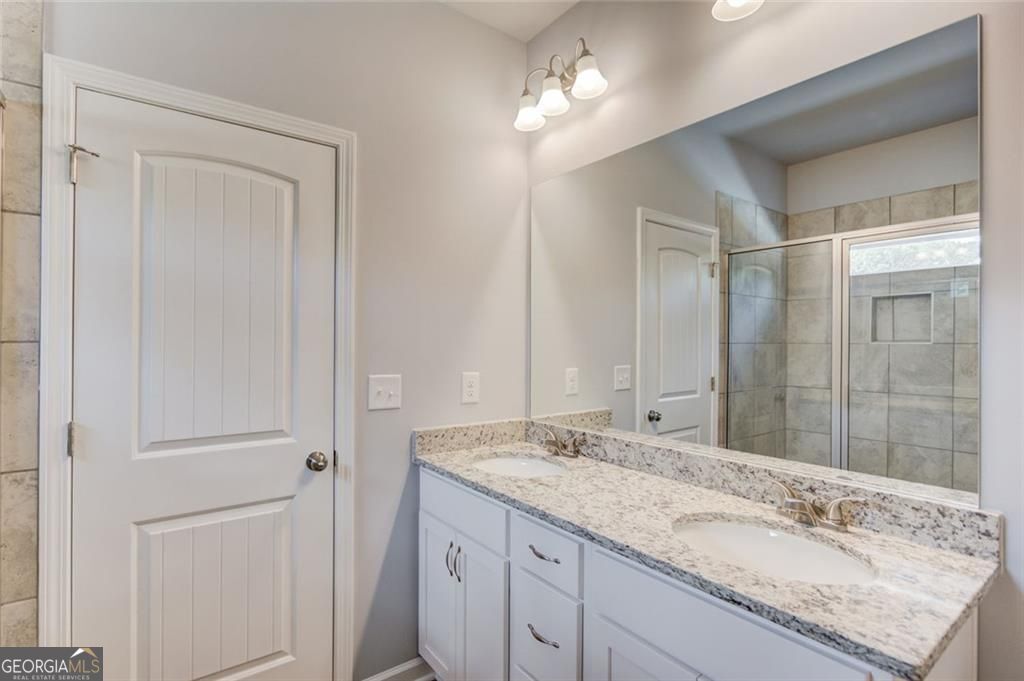 0 Harvest Church Road Clarkesville, GA 30523 - Photo 24 of 38 a bathroom with a granite countertop sink and a mirror