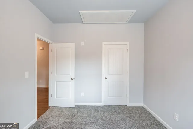 an empty room with closet area