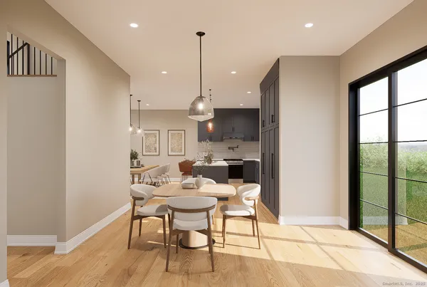 a dining room with furniture and a floor to ceiling window