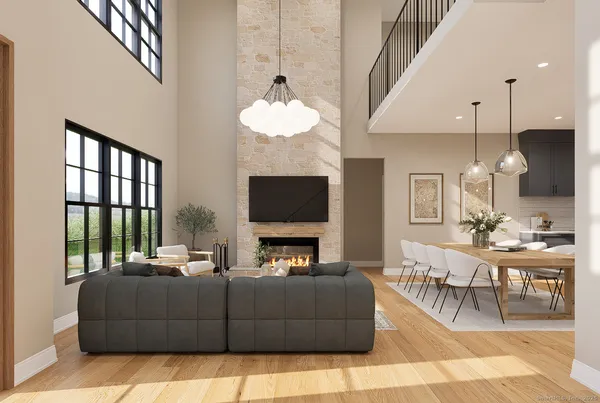 a living room with furniture chandelier and a flat screen tv