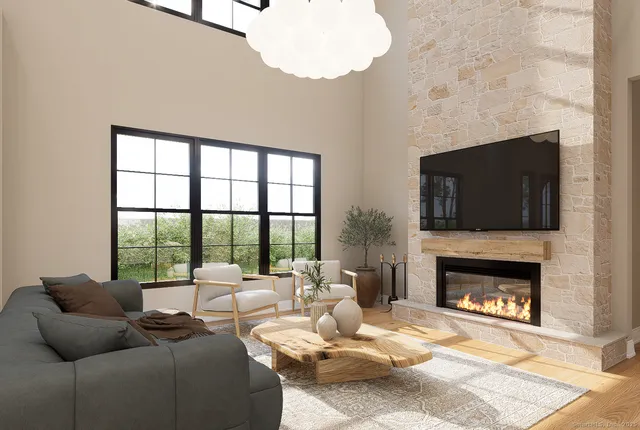 a living room with furniture large window and a fireplace