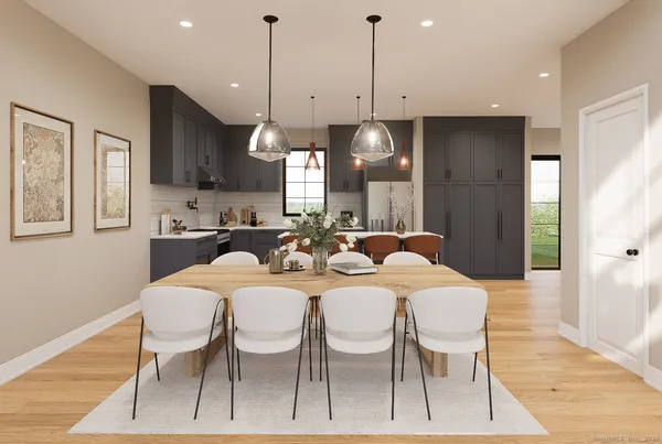 a large kitchen with a table and chairs