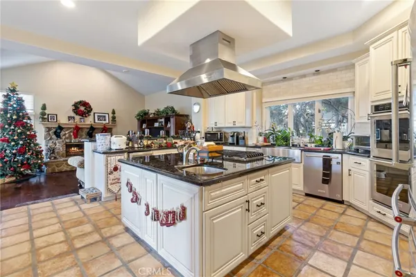 a kitchen with stainless steel appliances granite countertop a sink and cabinets