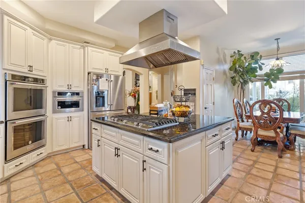 a dining room with furniture and a kitchen view