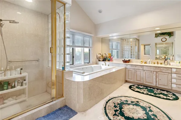 a bathroom with a double vanity sink mirror and shower