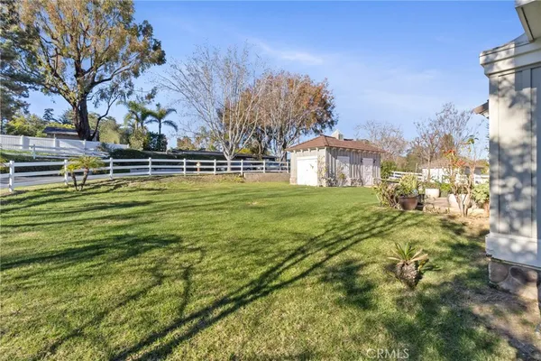 a view of a yard with a house in the background