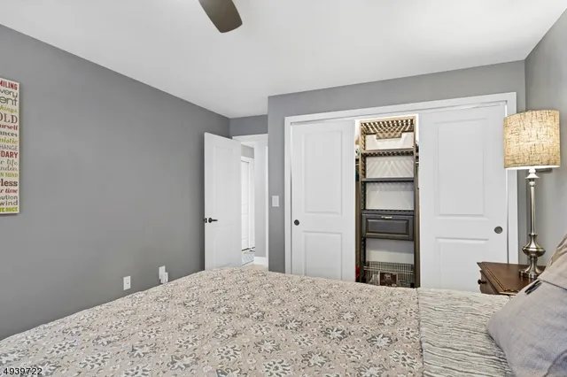 a bedroom with a bed and painting on the wall