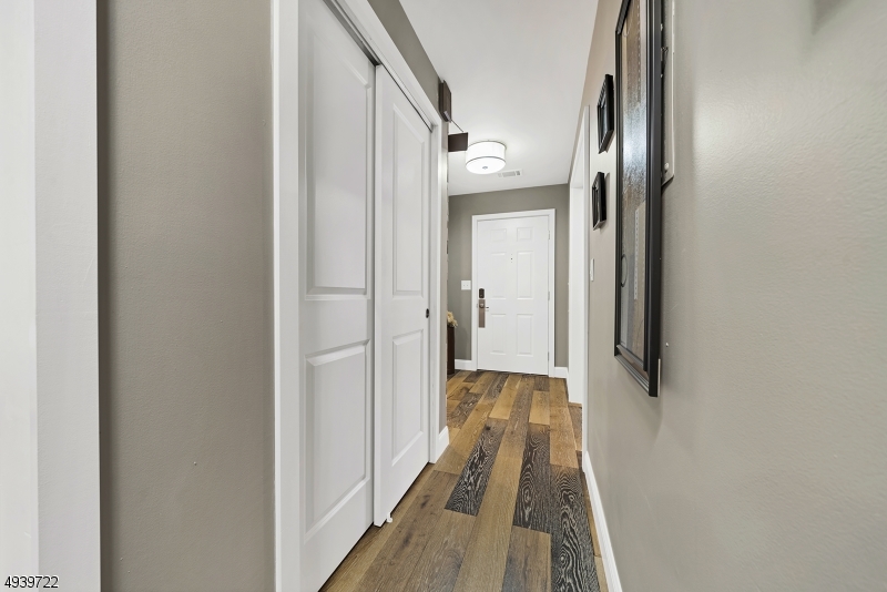 323 Sparrow Court Three Bridges, NJ 08887 - Photo 13 of 20 a view of a hallway with wooden floor and staircase