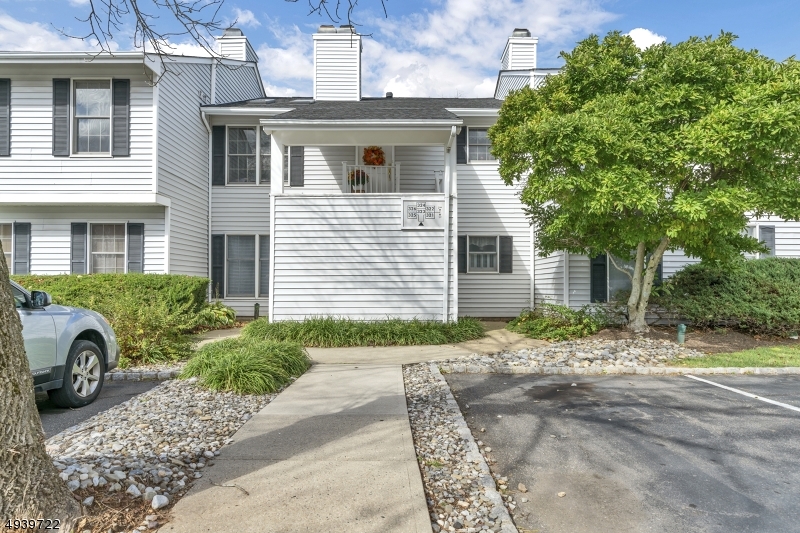 323 Sparrow Court Three Bridges, NJ 08887 - Photo 16 of 20 a front view of a house with a yard and garage