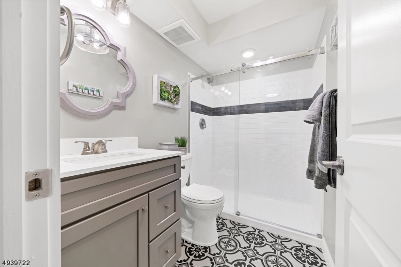 323 Sparrow Court Three Bridges, NJ 08887 - Photo 10 of 20 a bathroom with a sink a toilet and a mirror