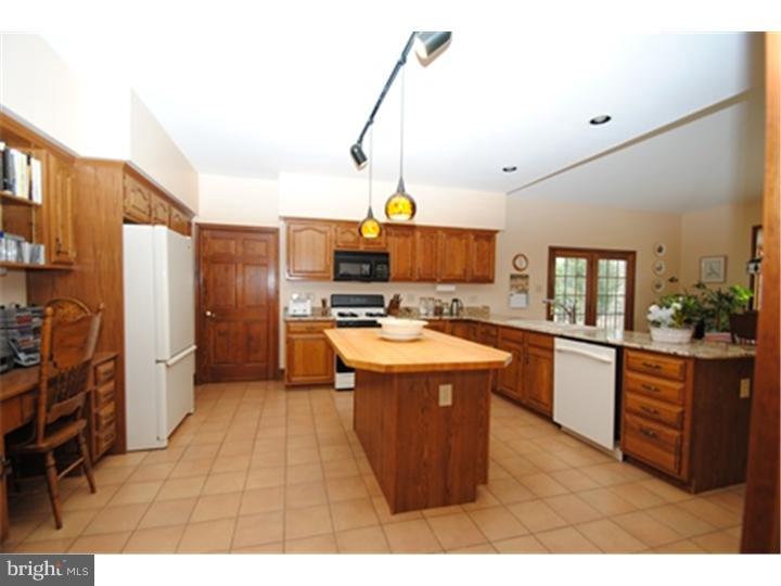 158 North Post Road Princeton Junction, NJ 08550 - Photo 5 of 23 a kitchen with stainless steel appliances kitchen island granite countertop a sink a counter space and a view of living room