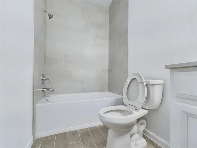 a bathroom with a toilet a sink and bathtub