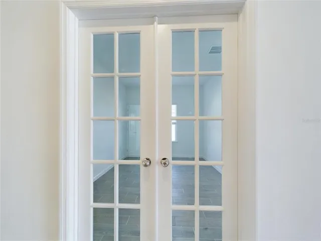 a view of a room with wooden door