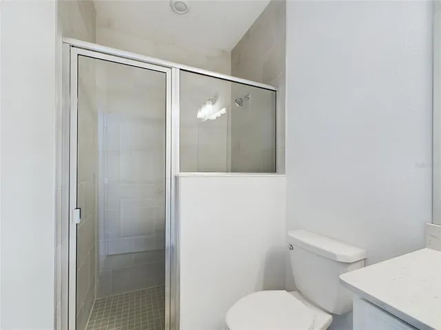 a bathroom with a toilet and a shower