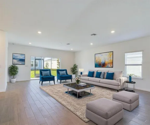 a living room with furniture and wooden floor