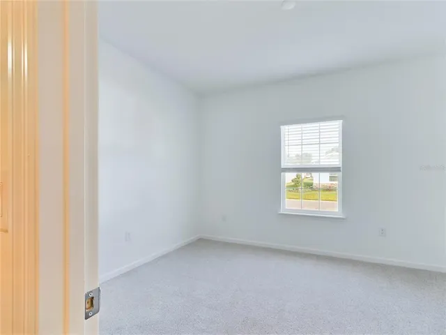a view of an empty room and a window