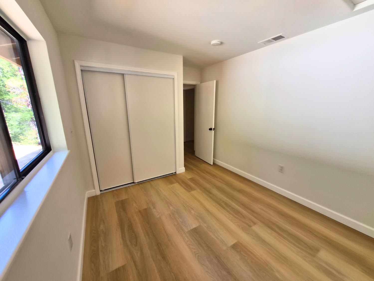 21640 Clute Canyon Road Volcano, CA 95689 - Photo 11 of 44 a view of hallway with a large window and wooden floor