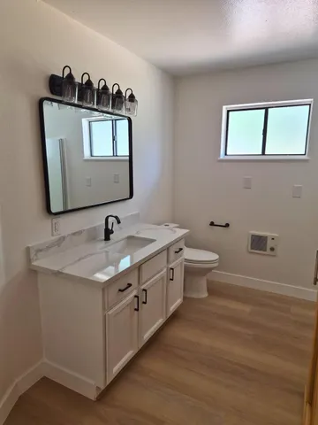 a bedroom with a bed a couch and potted plant