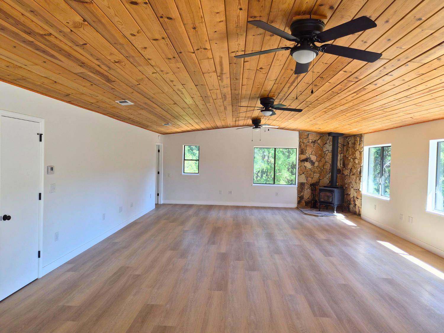 21640 Clute Canyon Road Volcano, CA 95689 - Photo 16 of 44 a view of empty room with wooden floor and fan