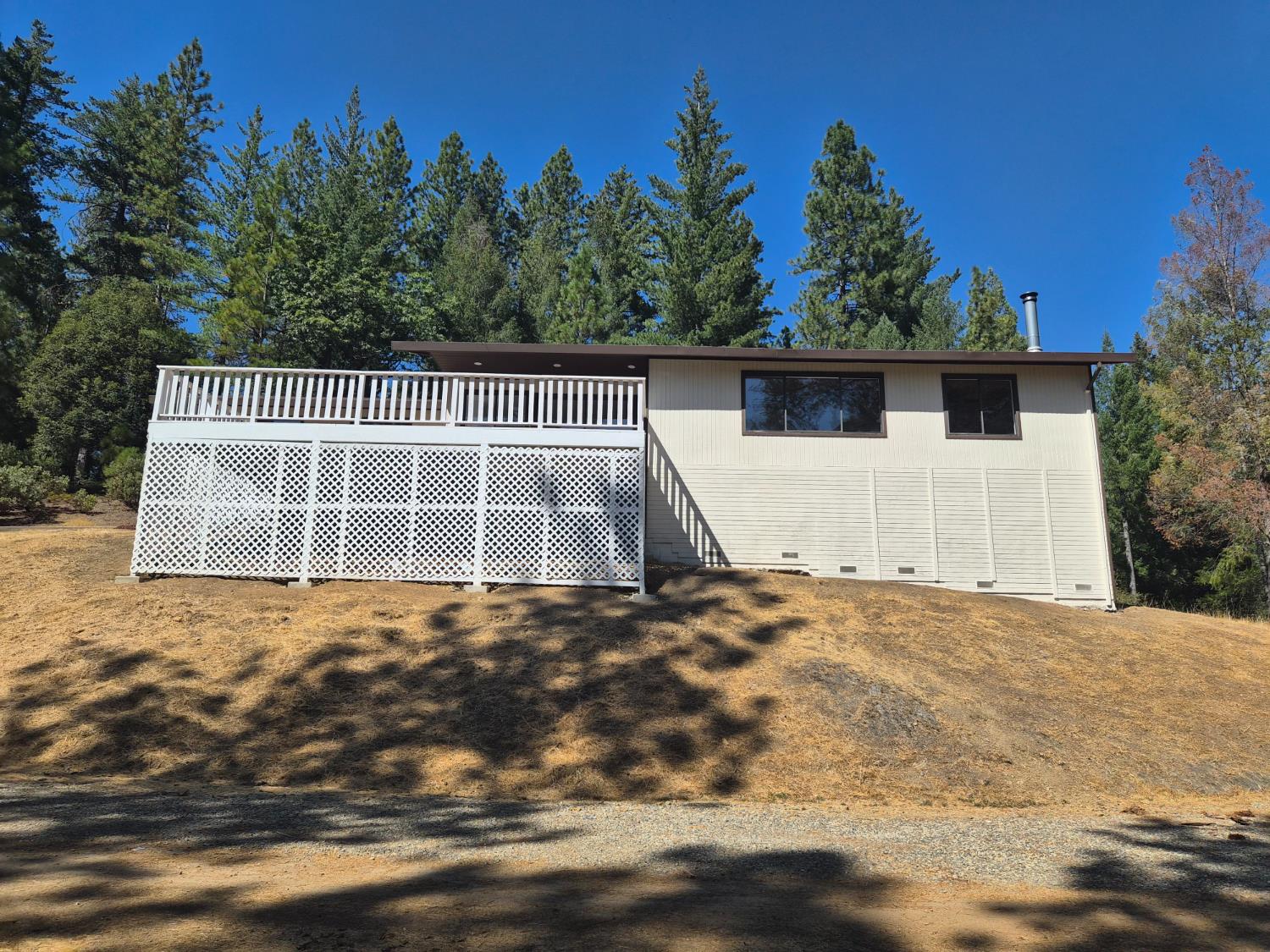 21640 Clute Canyon Road Volcano, CA 95689 - Photo 32 of 44 a view of a house with backyard and trees