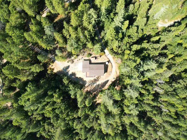 an aerial view of a house with yard and garage