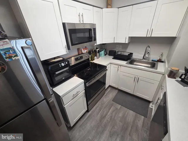 a kitchen with a sink stove and microwave