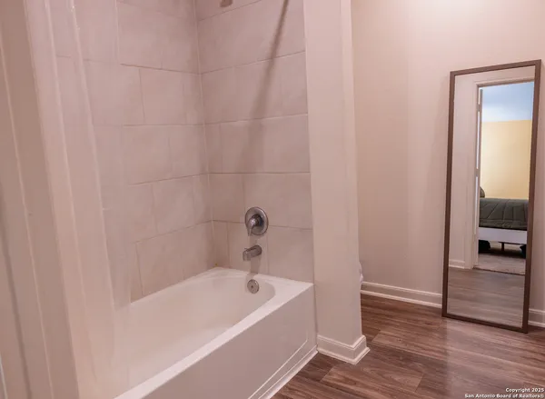 a bathroom with a bathtub and a shower