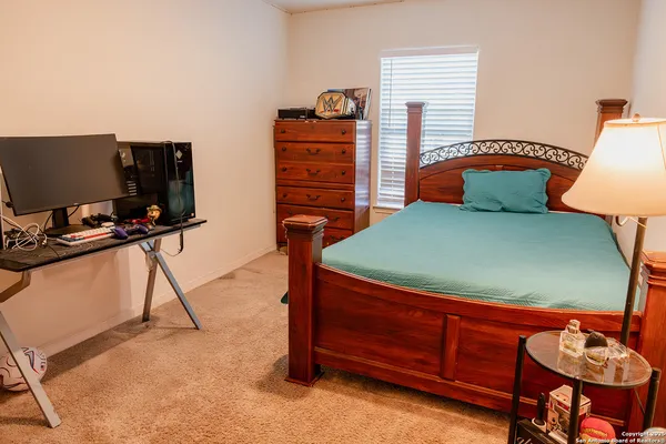 a bedroom with a bed and a television