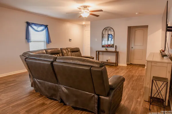 a living room with furniture and a wooden floor