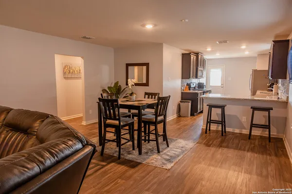 a view of a dining room with furniture and wooden floor