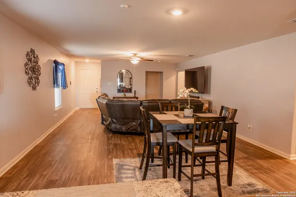a view of a dining room with furniture and wooden floor