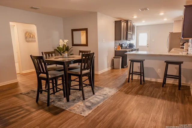 a view of a dining room with furniture and wooden floor