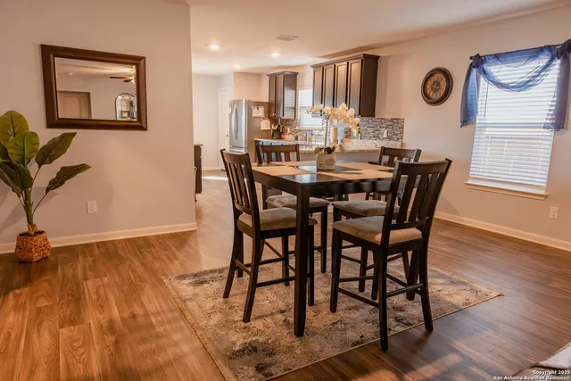 a view of a dining room with furniture and wooden floor